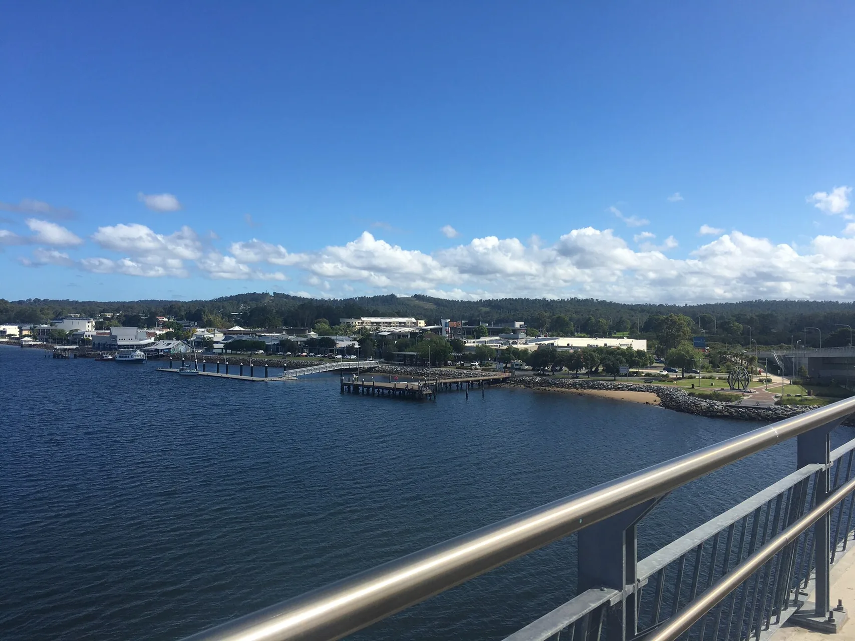 A wide view of the Batemans Bay shore and CBD as seen from the Clyde River Bridge