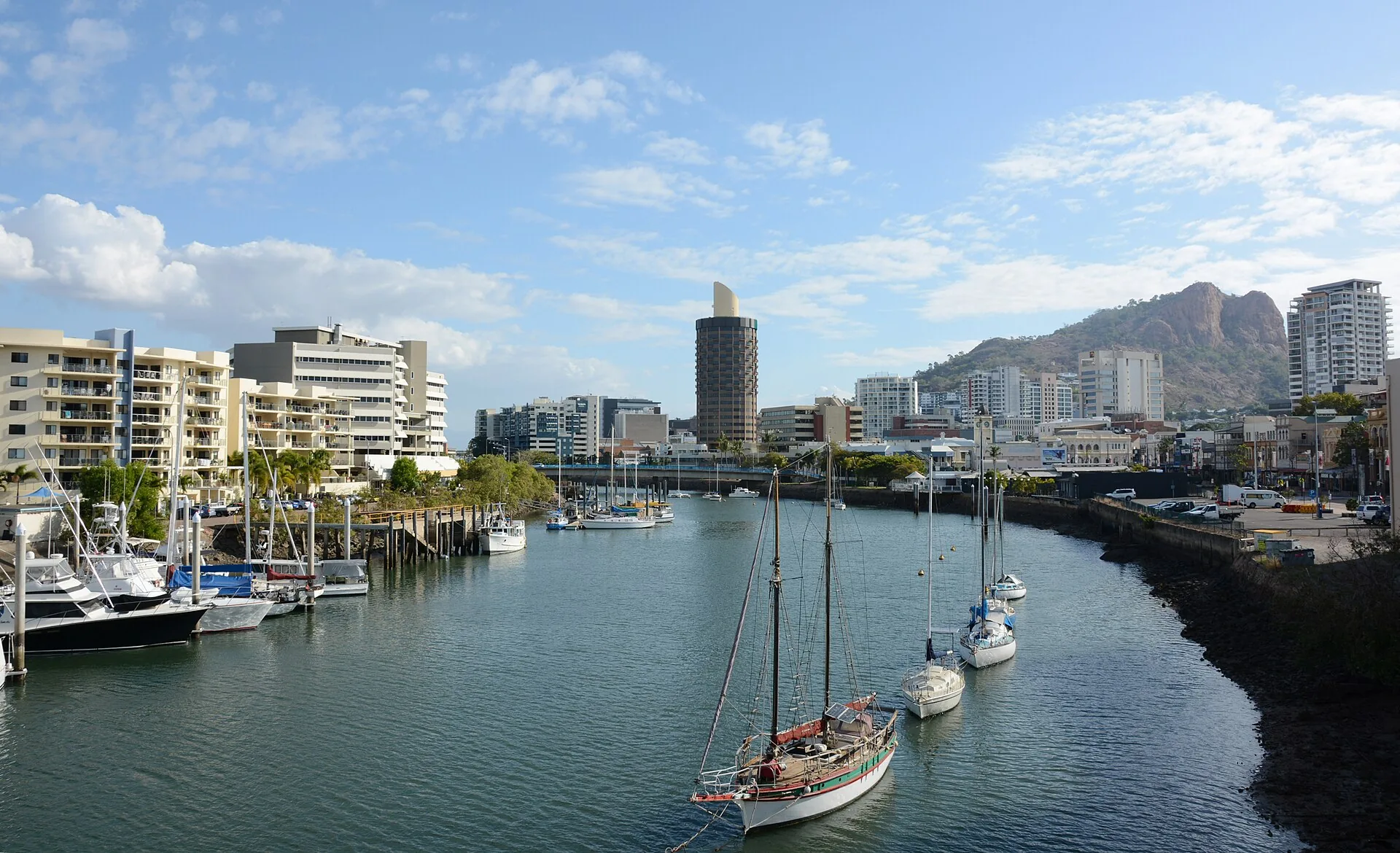 Ross River flowing through Townsville CBD with the Castle Hill in the background. The building seen in the middle of the picture is the iconic "Sugar Shaker", it is now Hotel Gran…