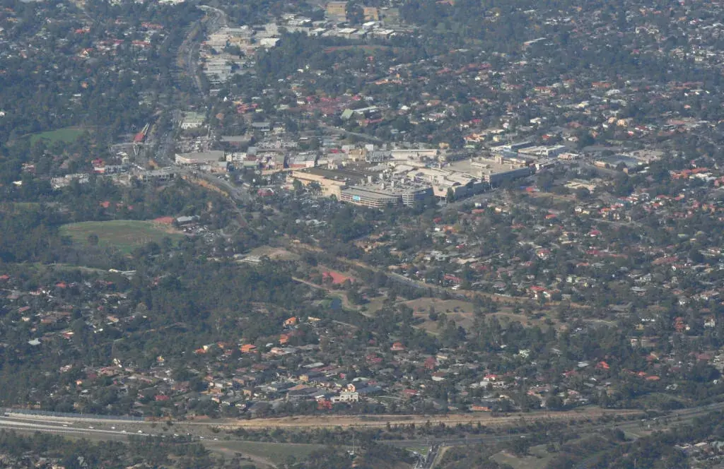 Overview of Greensborough, Victoria from the north, Greensborough Bypass just in foreground and to right, Greensborough Plaza in centre of image, Greensborough railway station, Me…