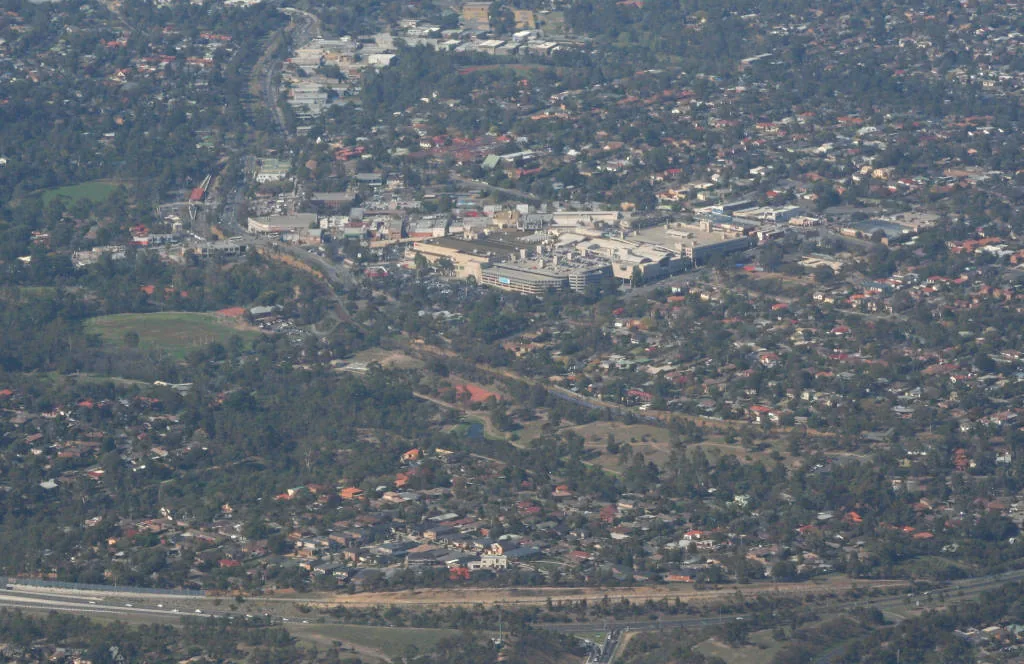 Overview of Greensborough, Victoria from the north, Greensborough Bypass just in foreground and to right, Greensborough Plaza in centre of image, Greensborough railway station, Me…